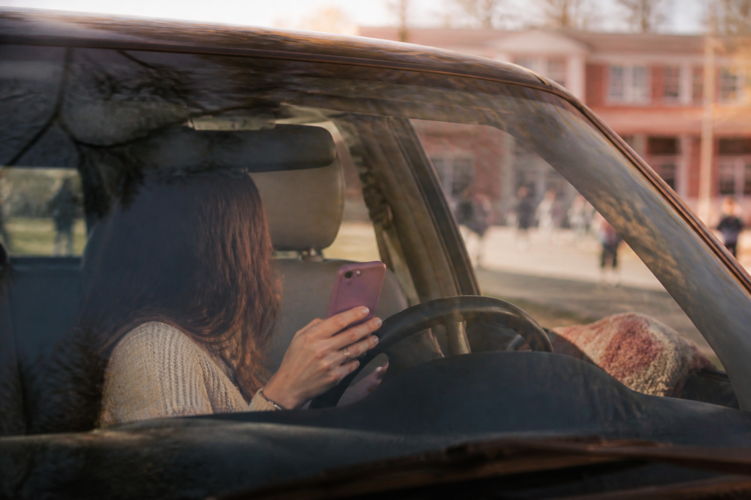 Phone held in a parked car during a school pickup